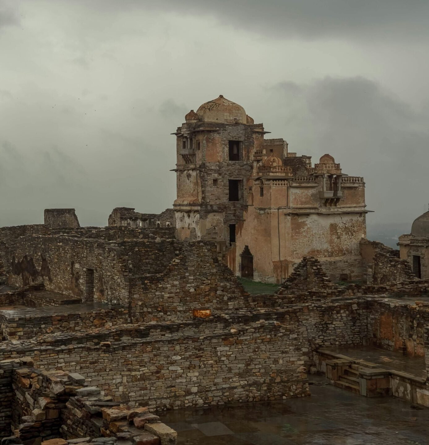 Explore the ancient ruins of Chittorgarh Fort, Rajasthan, showcasing historic architecture against stormy skies.